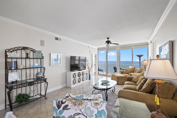Spacious Living Room with 65" TV, Stereo and DVD player.