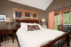 Main level master bedroom with private entrance to hot tub area and private bathroom.