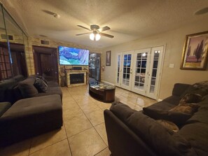 Living room with a giant smart tv and a powerful surround sound system