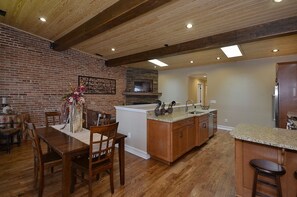 The kitchen bartop offers overflow seating in addition to the dining area