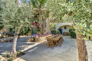 The two old olive trees standing sentry over the spacious dining area