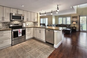 Fully stocked kitchen open to living/dining area