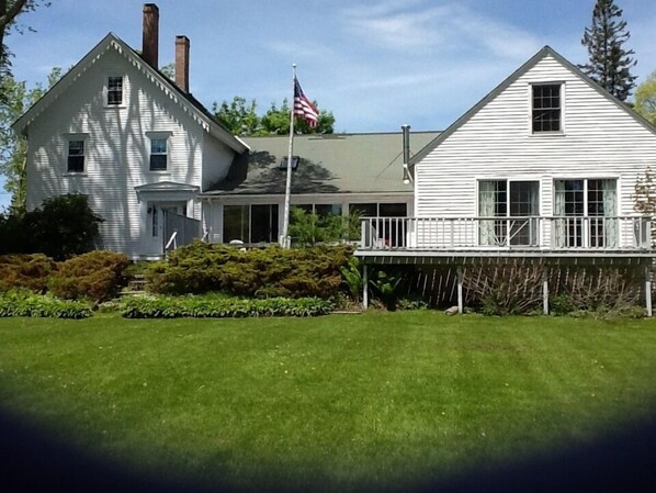 Back of house and large yard.  Deck off of sun room and ground level bedroom
