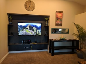 70" HDTV, entertainment center, and information desk with Zion guide book.
