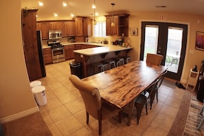 Kitchen and dining room table, seating for 8-10 people. 