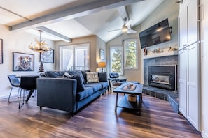 Bright and updated living area with gas fireplace and flat scree