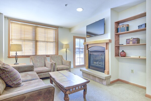 Living Area - Queen size sofa sleeper, flat screen TV, and access to private balcony.