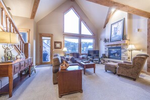 Living Area - Vaulted ceiling, natural light, and large windows.