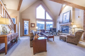 Living Area - Vaulted ceiling, natural light, and large windows.