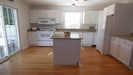 Eat in kitchen with new, white table for four.  Granite counter tops
