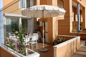 Have a seat under the shade on the patio.