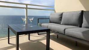 Enjoy our comfortable balcony sofa and our Penthouse GLASS railings!