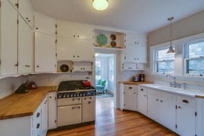 sunny kitchen with vintage cabinets and chef's dream Aga stove