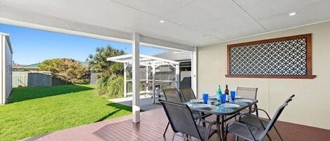 Undercover alfresco dining leading out to bbq area and large flat secure yard