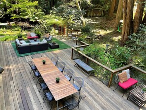 Full View of front deck, multiple seating areas all in a redwood grove.