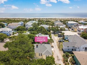 Gorgeous drone shot of Mullet Manor and the beach