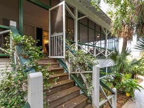 Steps leading to wrap around screened porch