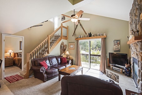 Living room with entry to downstairs bed and bath.
