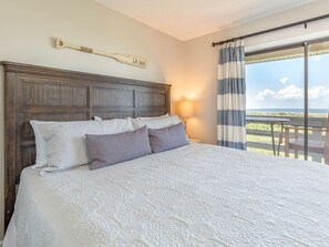 Master Bedroom with King Bed, TV, Attached Bath and Access to Balcony