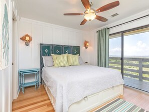 Master Bedroom with Queen Bed, TV, attached Bath and Balcony Access