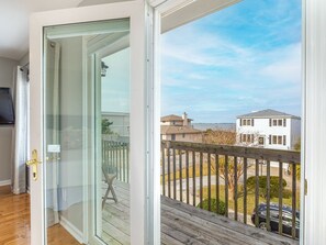 Top floor Bedroom 1 with King bed, TV and attached balcony