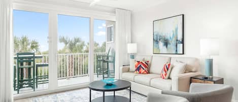 Living area with sleeper sofa and access to oceanfront balcony