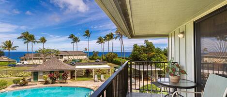 Alii Kai 8H has a private balcony lanai overlooking one of the complex pools and the Pacific Ocean in the background
