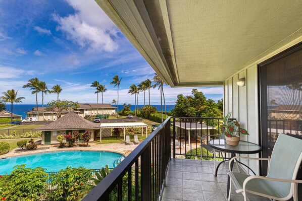 Alii Kai 8H has a private balcony lanai overlooking one of the complex pools and the Pacific Ocean in the background