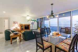 The large living and dining space overlooks the ocean
