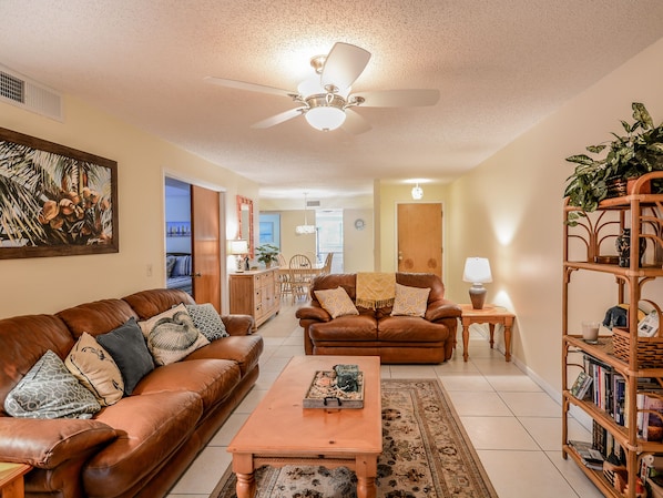 Decorated with Florida style, this lovely living room features a flat screen HDTV, DVD player, leather couch and love seat.