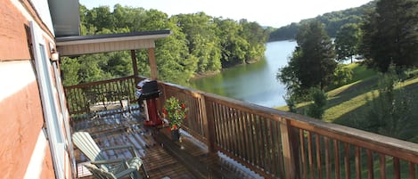 Top deck/wrap around porch with Weber gas grill.