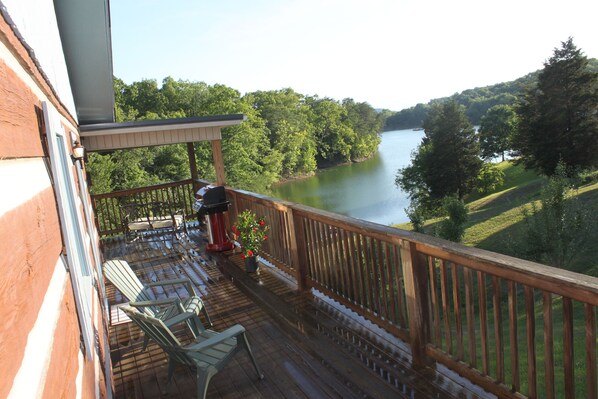 Top deck/wrap around porch with Weber gas grill.