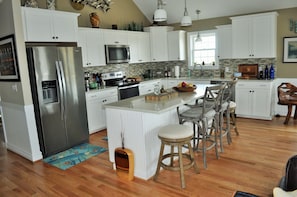 Fully appointed kitchen, recycled glass counters.  Service for 16.