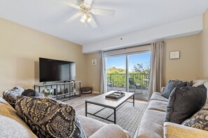 Spacious living room with a flat-screen TV, DVD, and VCR.