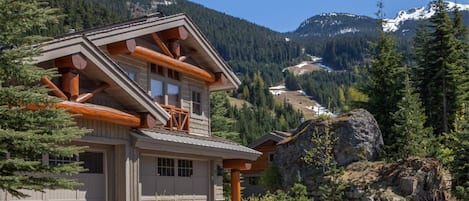 Exterior of our home in the Spring.  Peak to Creek ski run in background 
