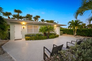 Relaxing patio and beach boardwalk is on the other side of the hedges