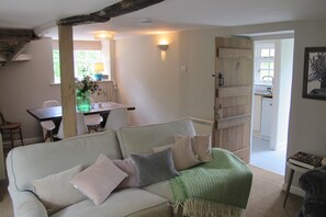 Sitting room, log burner and Samsung TV in front of sofa