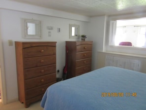 Another view of bedroom showing two bureaus. There's also a large closet