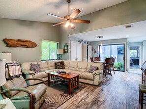 This New Smyrna beach vacation rental's living room also offers access to the patio.