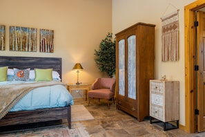 Right side of master bedroom with bathroom door on right.