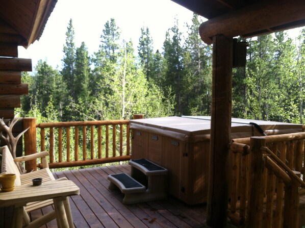 Incredible deck with hot tub and outdoor seating facing National Forest