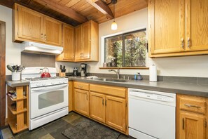 Kitchen has a sliding glass door that opens to grill and back deck