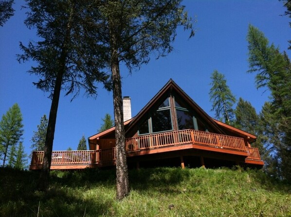 Looking up to Chalet. Outdoor hottub on the left.