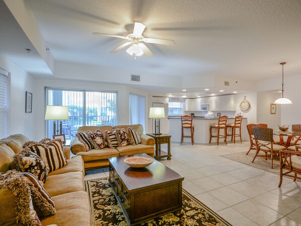 Tastefully decorated living room with Tommy Bahama style decor, 60" flat screen HDTV and DVD.