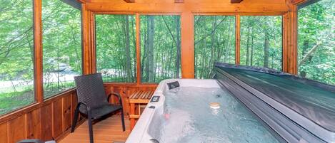 Take in the mountain air while relaxing in this screened in deck with hot tub!