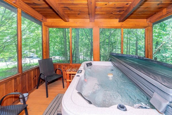 Take in the mountain air while relaxing in this screened in deck with hot tub!