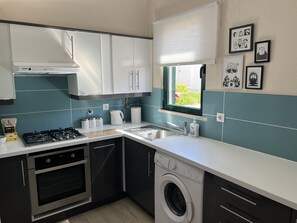 Kitchen with breakfast bar, coffee maker, dishwasher, microwave, washing machine