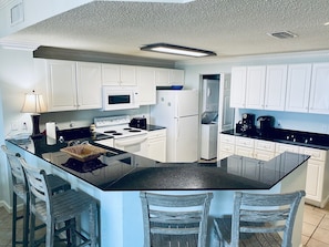 Kitchen w/ spacious kitchen and granite countertops 
