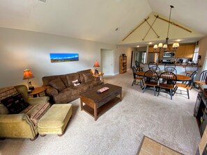 Living/Dining Area is an open concept area with a dining table that seats 6 and comfortable furniture surrounding the fireplace.