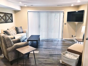 Full view of Living Room with patio and blinds
